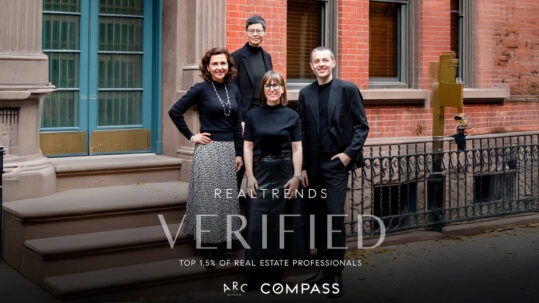ARC Residential team posing in front of a Manhattan brownstone to celebrate ranking in the top 1.5% of real estate agents nationwide on the RealTrends Verified list.